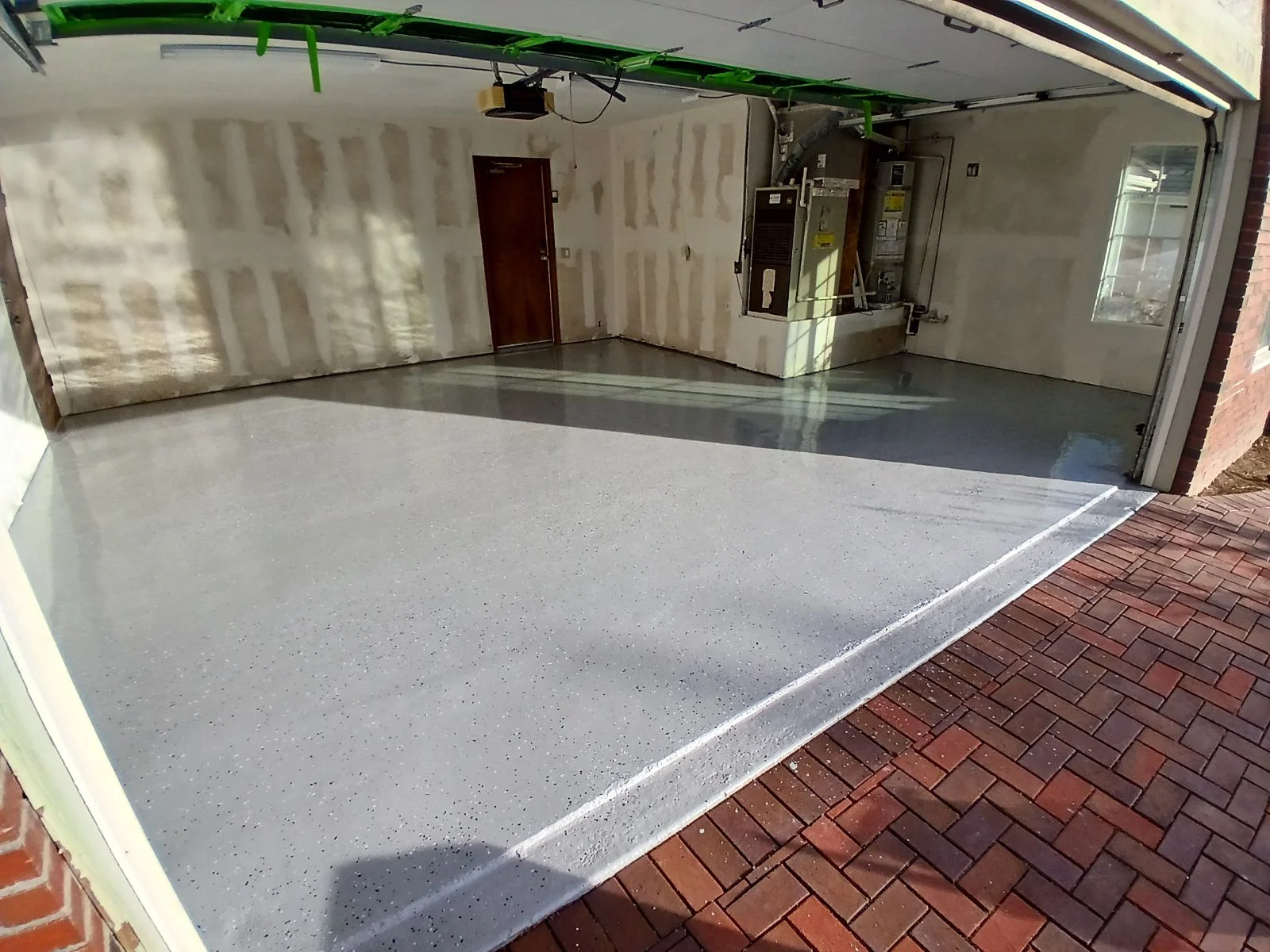 Gray speckled epoxy-coated garage floor with beveled edge and finished interior walls