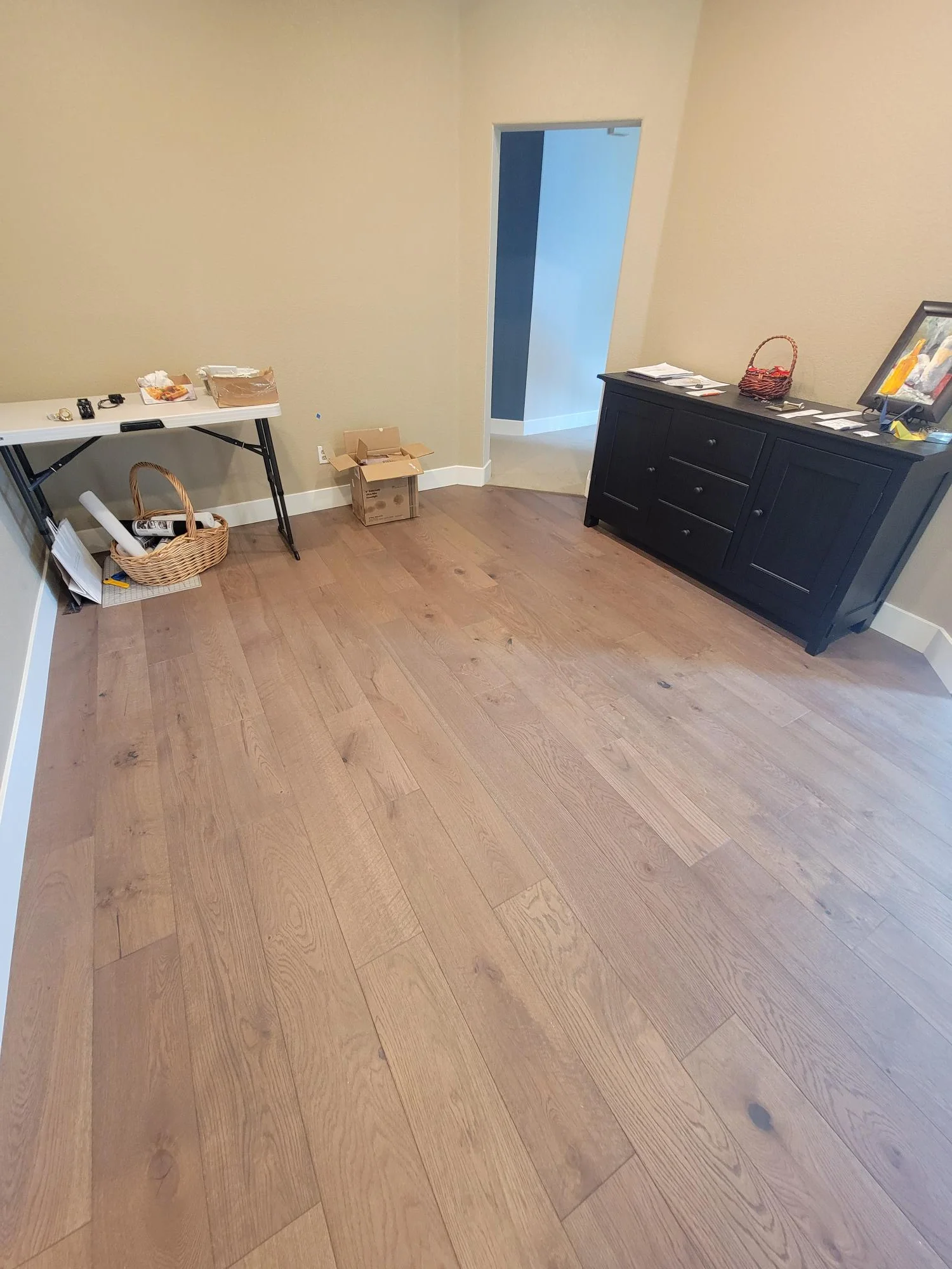 Light oak hardwood flooring with natural grain pattern installed in residential room