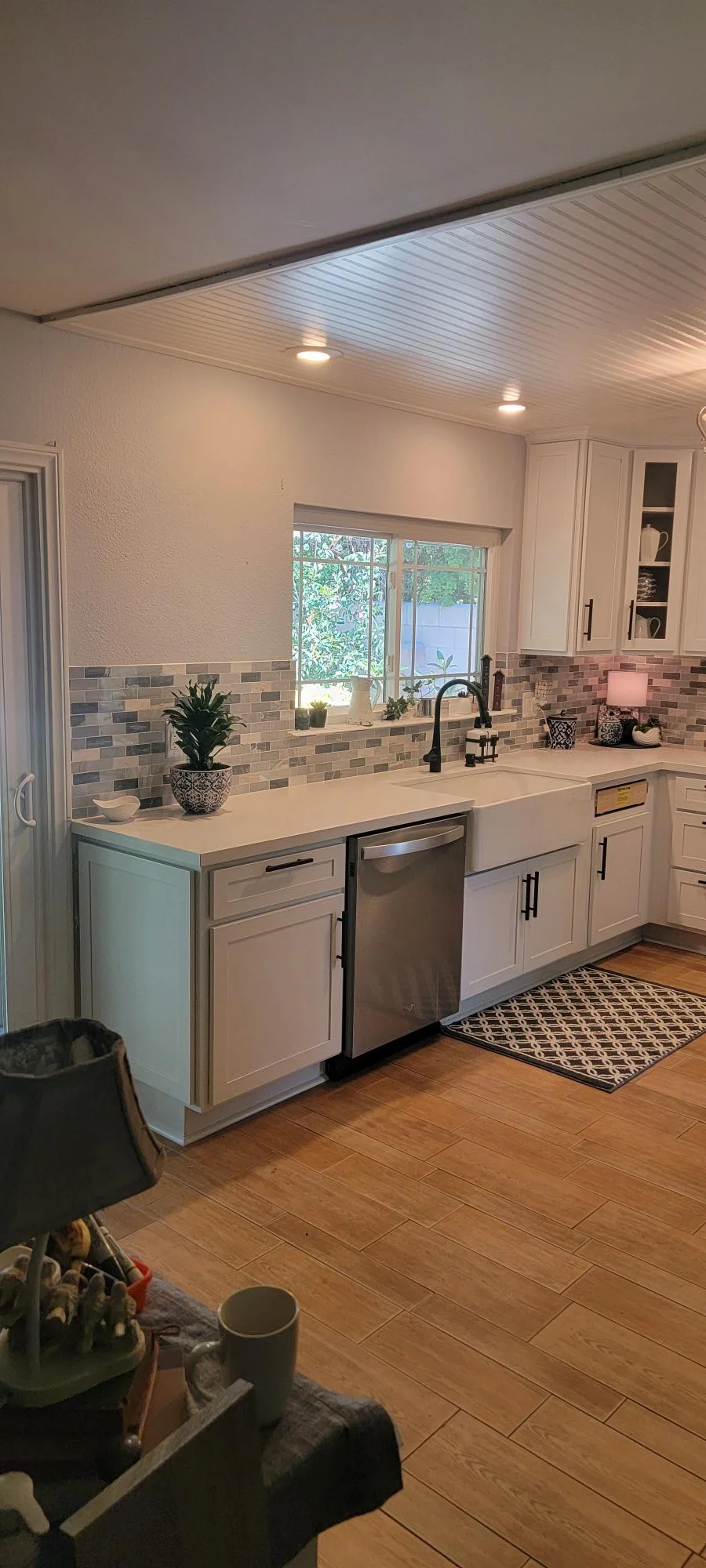 Modern kitchen with white cabinets, quartz counters, subway tile backsplash, and recessed lighting