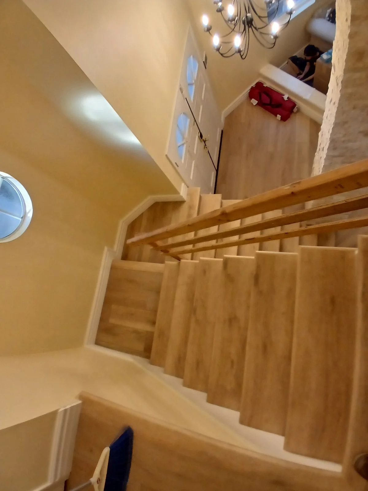 Wood staircase with handrail, painted drywall walls, and recessed lighting in residential interior